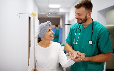 Doctor Holding Hands with Cancer Patient