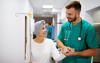 Doctor Holding Hands with Cancer Patient